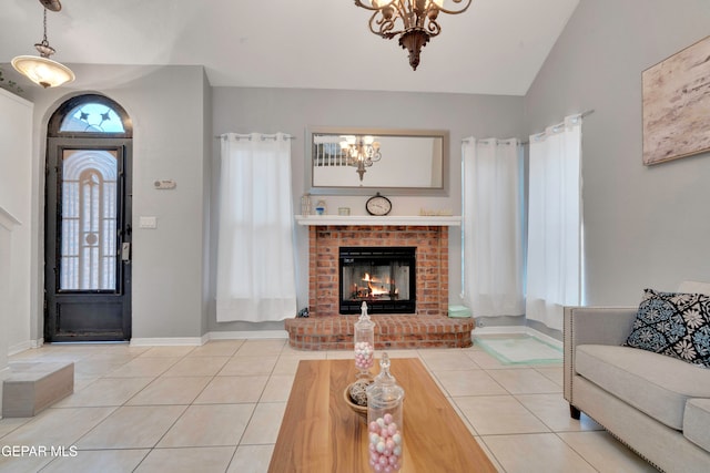 living room featuring plenty of natural light, lofted ceiling, light tile patterned floors, and an inviting chandelier