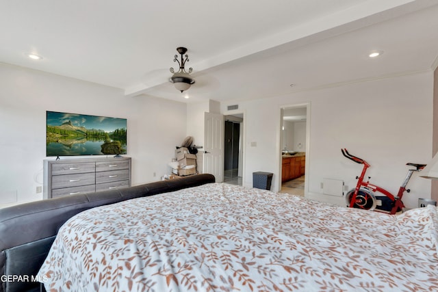 bedroom with beam ceiling, ensuite bath, and ceiling fan