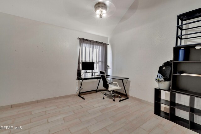 office area featuring light hardwood / wood-style flooring and lofted ceiling