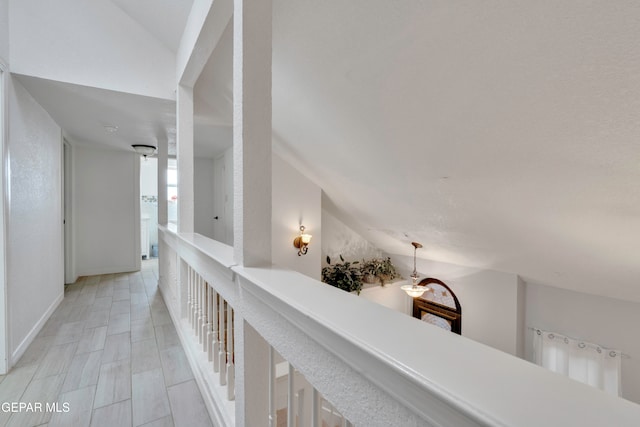 hall featuring lofted ceiling