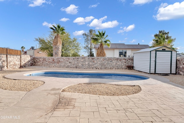 view of pool featuring a shed