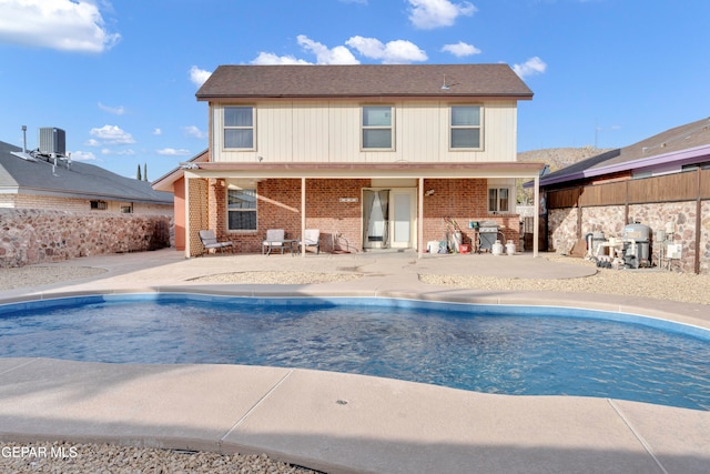 view of pool featuring a patio area, grilling area, and central AC unit