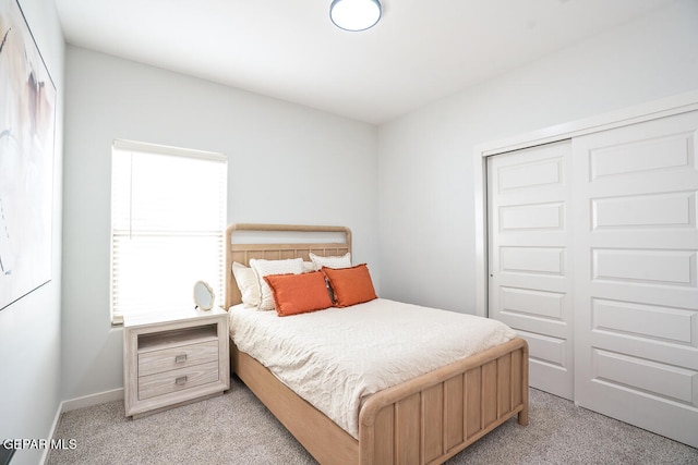 carpeted bedroom with a closet