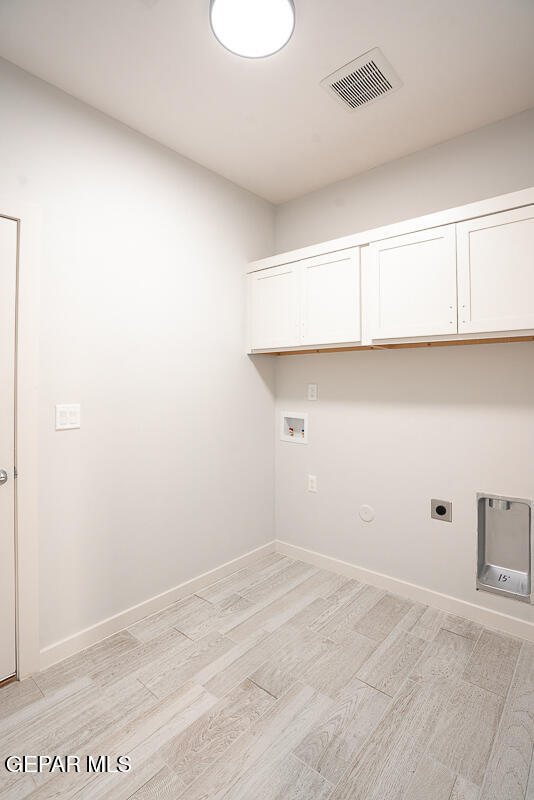 laundry room with washer hookup, hookup for an electric dryer, cabinets, and gas dryer hookup