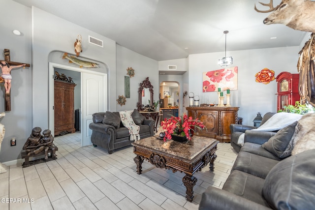 living room with light hardwood / wood-style flooring and vaulted ceiling