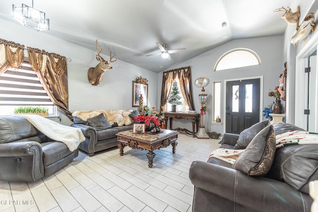 living room with ceiling fan and vaulted ceiling