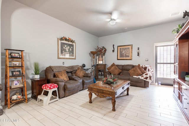 living room featuring ceiling fan and light hardwood / wood-style floors