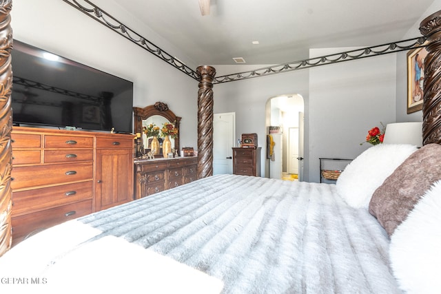 bedroom with connected bathroom and lofted ceiling