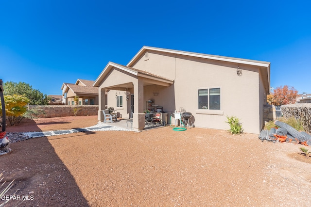 back of property with a patio