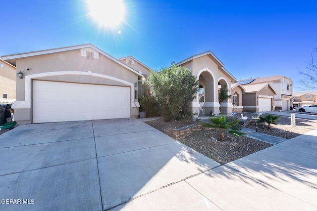 view of front of property featuring solar panels and a garage