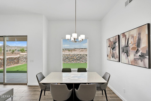 dining space with a chandelier and wood-type flooring