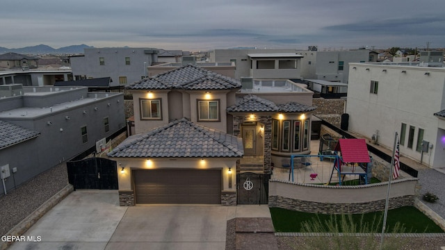 view of front of home with a mountain view and a garage