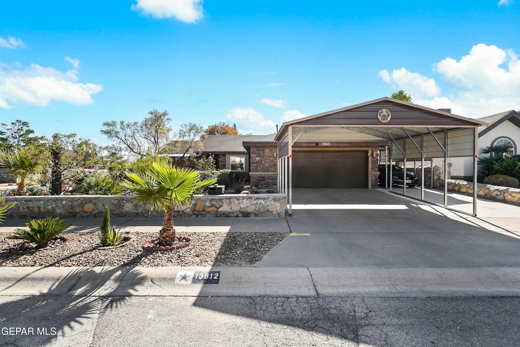 view of front of property with a carport and a garage