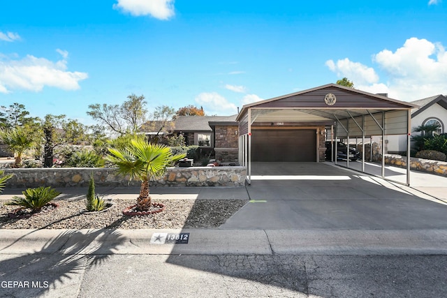 view of front of property with a carport and a garage