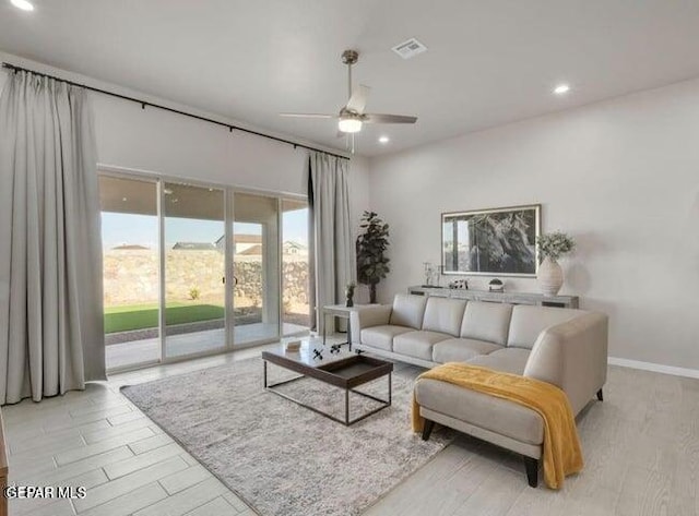 living room with light wood-type flooring and ceiling fan