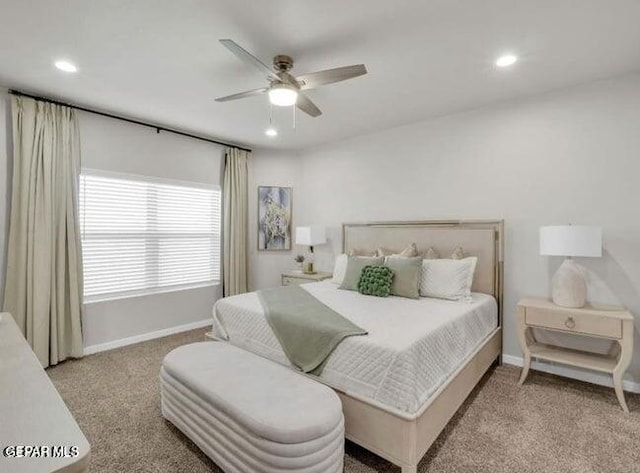 bedroom with ceiling fan and light carpet