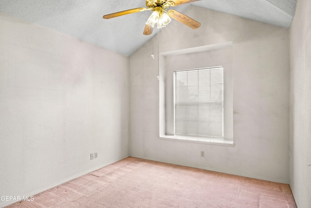 empty room featuring a textured ceiling, light carpet, ceiling fan, and lofted ceiling