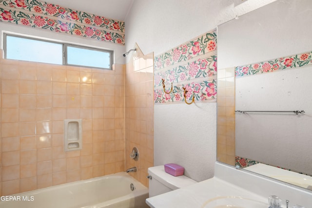 full bathroom with vanity, tiled shower / bath combo, and toilet