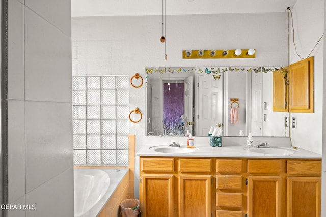 bathroom featuring vanity and a relaxing tiled tub