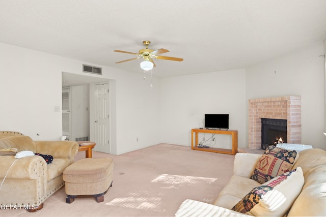 living room with light carpet, a fireplace, and ceiling fan