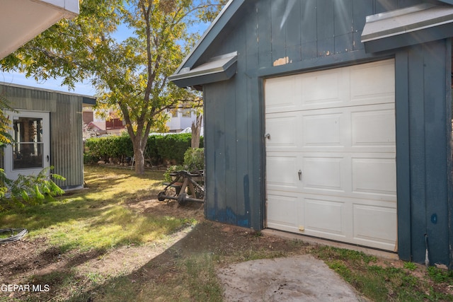 garage featuring a lawn