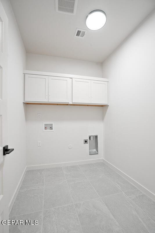 laundry room featuring cabinets, gas dryer hookup, hookup for an electric dryer, and washer hookup