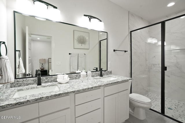 bathroom featuring vanity, tile patterned flooring, a shower with door, and toilet