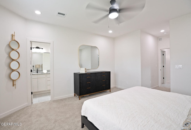 carpeted bedroom featuring ceiling fan, sink, and ensuite bath