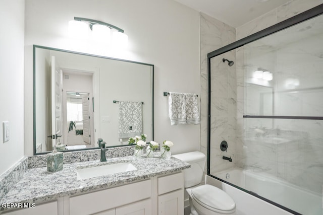 full bathroom with vanity, shower / bath combination with glass door, and toilet