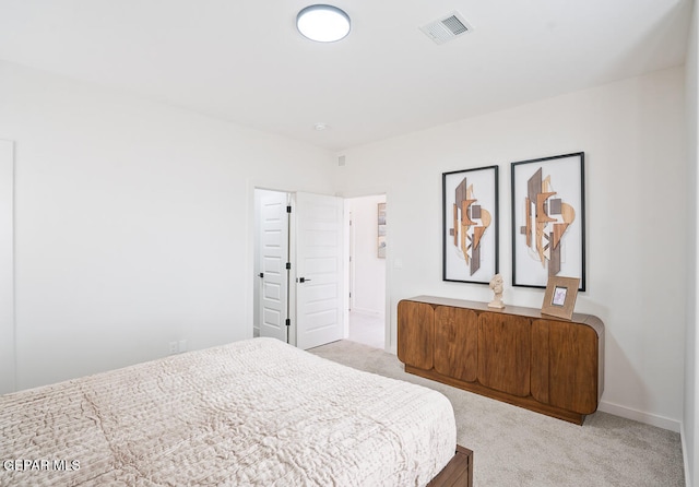 bedroom featuring light carpet