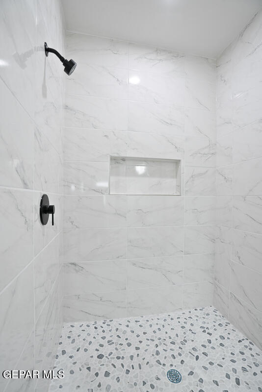 bathroom with tiled shower