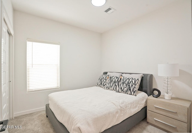 bedroom with light colored carpet