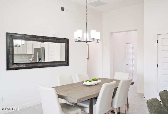 tiled dining space with an inviting chandelier