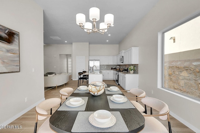 dining room featuring sink and a chandelier