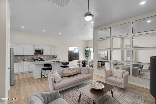 living room with sink and light hardwood / wood-style floors