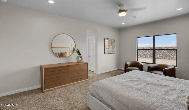 bedroom featuring ceiling fan and light carpet