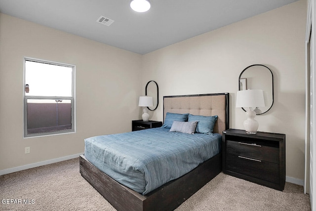 bedroom featuring light colored carpet