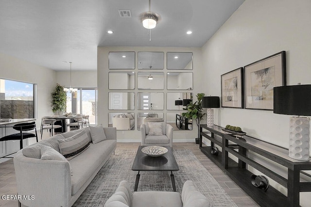 living room with hardwood / wood-style flooring and a notable chandelier