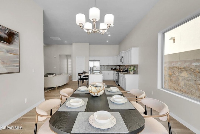 dining room with a chandelier and sink