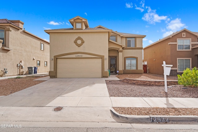 view of front facade with driveway and stucco siding