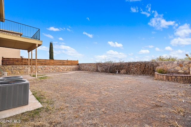 view of yard with cooling unit and fence