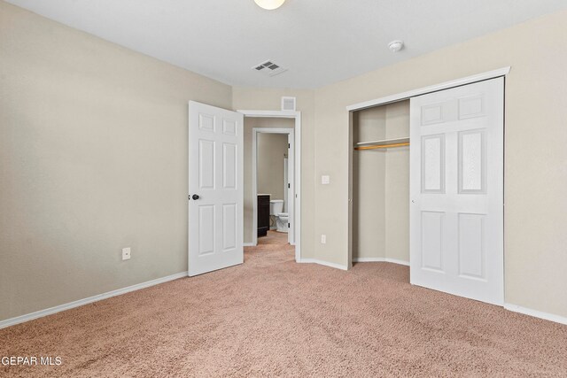 unfurnished bedroom featuring a closet, carpet flooring, visible vents, and baseboards