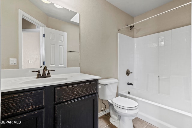 full bath featuring shower / bath combination, a textured wall, toilet, tile patterned floors, and vanity