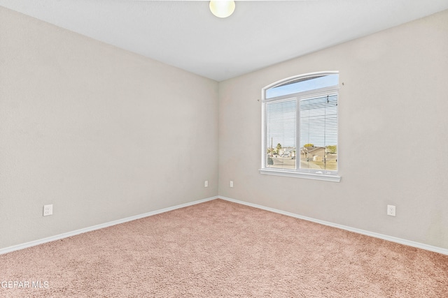 carpeted spare room with baseboards