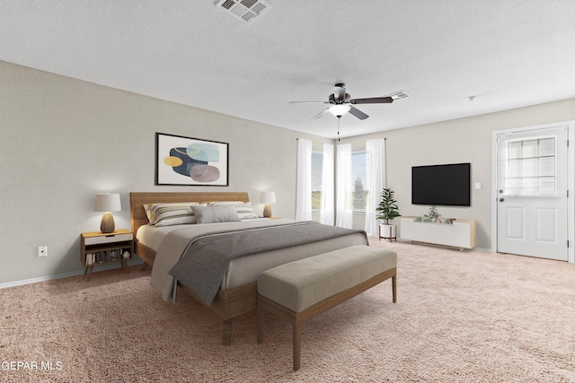 bedroom featuring a textured ceiling, carpet floors, and visible vents