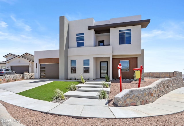 modern home featuring a garage and a balcony