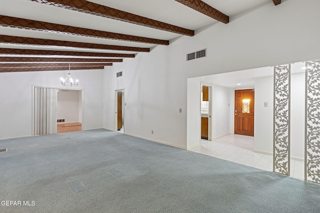 carpeted empty room with beam ceiling, high vaulted ceiling, and an inviting chandelier