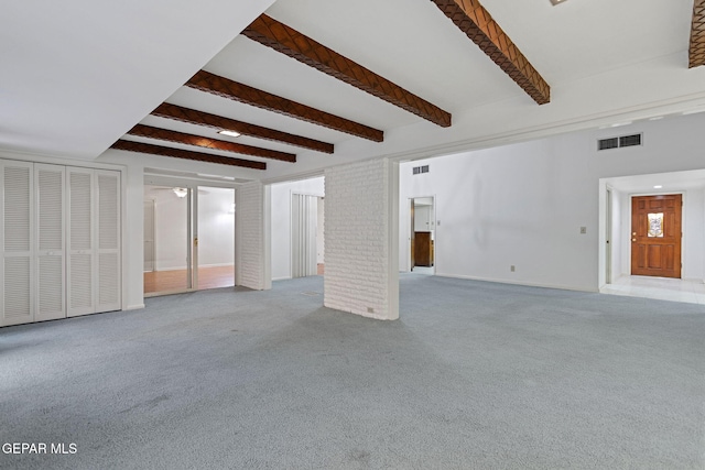 interior space with beam ceiling and light carpet