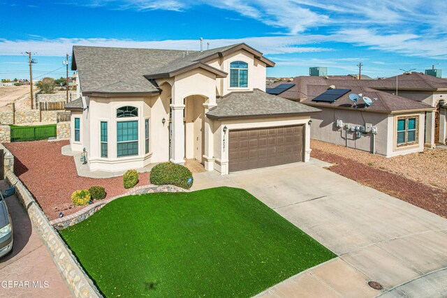 view of front facade featuring a front lawn and a garage