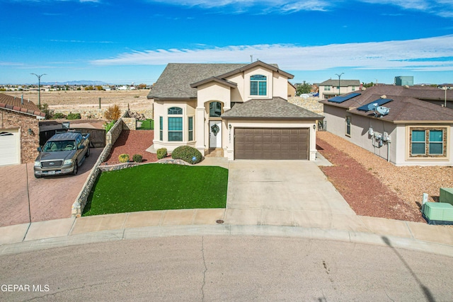 view of front facade featuring a front yard and a garage